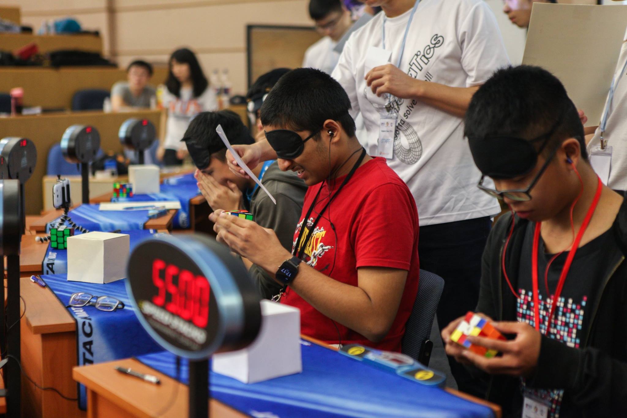 Several cubers competing in Rubik's Cube Competition
